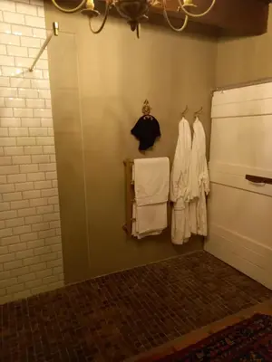 a room with white clothes hanging on a wall at Muratie Wine Estate in Stellenbosch