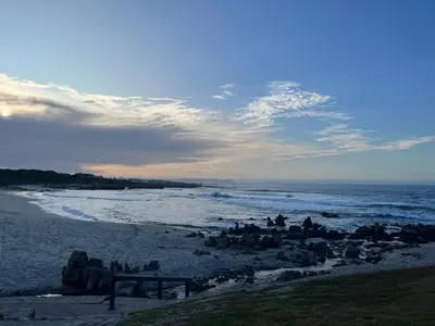 a group of people sitting on the beach at Matshana Lodge in Hermanus