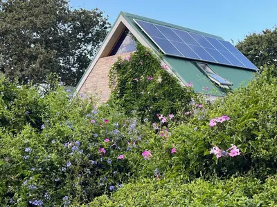 a house with a roof with solar panels on it at Matshana Lodge in Hermanus