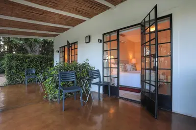 a room with chairs and a table and a bed at Elgin Country Lodge in Elgin