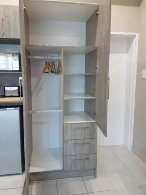 a walk in closet with wooden shelves in a kitchen at Studio on Bourdeaux in Panorama