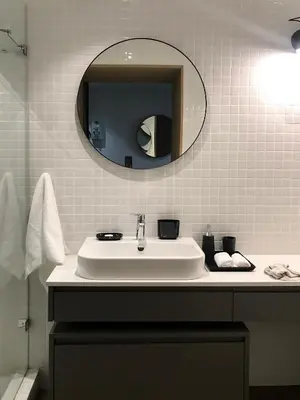 a bathroom with a white sink and a mirror at Eikehoff Apartments in Stellenbosch
