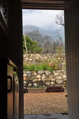 a view of a stone wall from a door at Kierie Kwaak Self Catering in Stellenbosch
