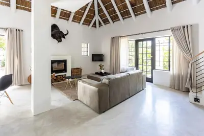 a living room with a couch and a fireplace at Africa Lodge in Somerset West