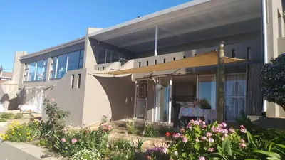 a house with flowers in front of it at Agape Apartments in Somerset West