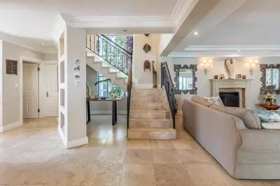 a living room with a staircase and a couch at Maison du Cap in Cape Town