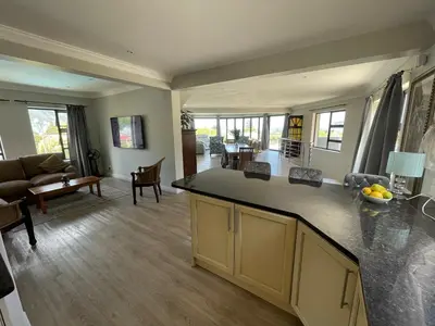 a kitchen and living room with a counter top at Bird's View Guest Accommodation in Hermanus