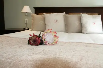 a bedroom with two flowers on a bed at Keren's Vine Guesthouse in Stellenbosch