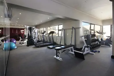 a gym with several treadmills and machines in a room at Hamewith Penthouse in Hermanus