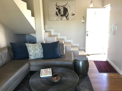 a living room with a couch and a table at Vilaroux in Stellenbosch