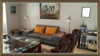 a living room with a couch and a glass table at 5 Pierre Jourdan in Franschhoek