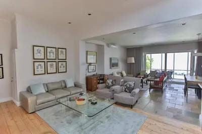 a living room with a couch and a table at Laanhof Victorian House Self-Catering in Stellenbosch