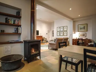 a living room with a wood stove in a room at Laanhof Victorian House Self-Catering in Stellenbosch