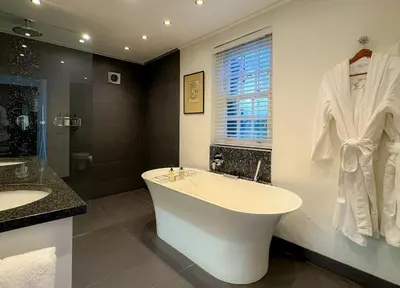 a bathroom with a tub and a shower and a sink at Grande Roche Hotel in Paarl