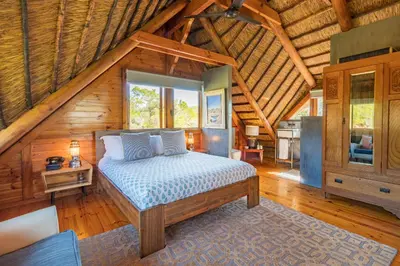 a bedroom with a bed in a wooden cabin at Tulbagh Mountain Cabin in Wolseley