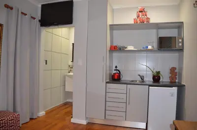 a kitchen with a counter and a sink in a room at Anni Bos in Stellenbosch