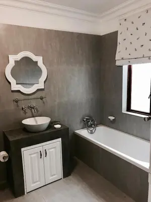 a bathroom with a sink and a bath tub at At Home in Mostertsdrift in Stellenbosch