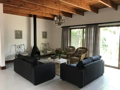 a living room with two couches and a fireplace at At Home in Mostertsdrift in Stellenbosch