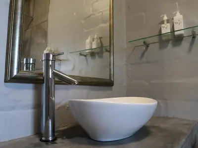 a white bowl sitting on top of a sink in a bathroom at Hemel en Aarde Village Accommodation in Hermanus