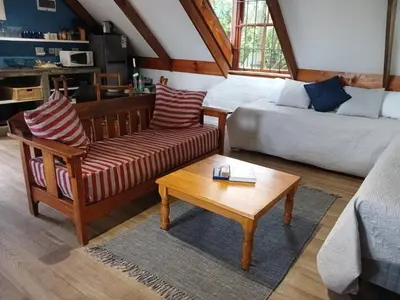 a living room with a couch and a coffee table at Hemel en Aarde Village Accommodation in Hermanus