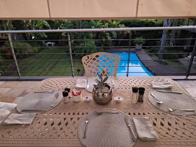 a table on a patio with a table sidx sidx sidx at Eversview Guesthouse in Durbanville