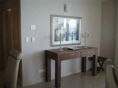 a wooden desk in a room with a window at Hibernian Towers 1802 Self Catering Accommodation Strand Western Cape South Africa in Strand
