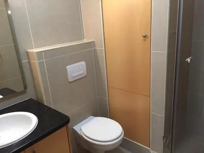 a bathroom with a toilet and a sink and a shower at Hibernian Towers 1802 Self Catering Accommodation Strand Western Cape South Africa in Strand
