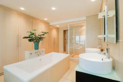 a bathroom with a large white tub and a sink at Ocean View 505 Self Catering Accommodation Strand Western Cape South Africa in Strand