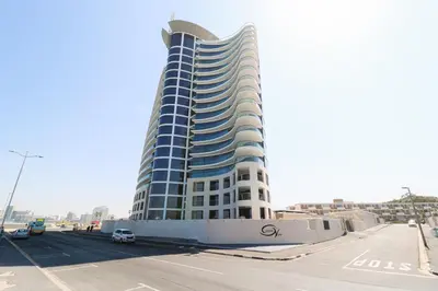 a tall blue and white building next to a street at Ocean View 505 Self Catering Accommodation Strand Western Cape South Africa in Strand