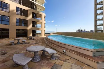 a swimming pool on the side of a building at Ocean View 905 Self Catering Accommodation Strand Western Cape South Africa in Strand