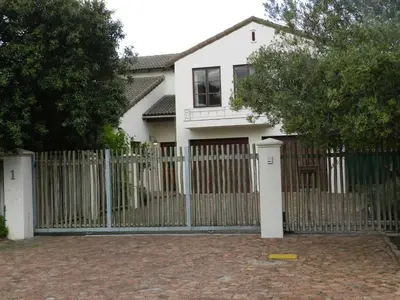 a white fence in front of a white house at Sunset at Diluta in Cape Town