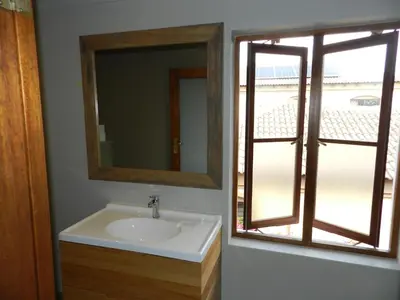 a bathroom with a sink and a mirror and a window at Sunset at Diluta in Cape Town