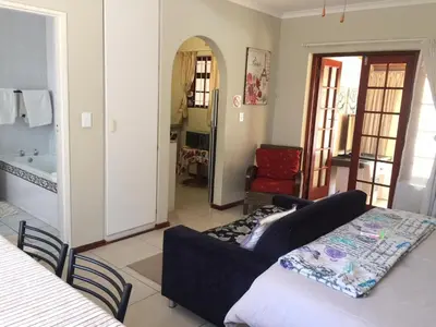 a living room with a couch and a table at Arum Field Accommodation in Table View