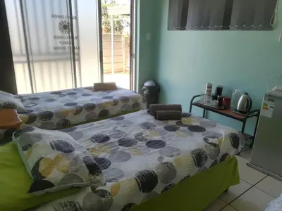 a bedroom with a bed with a comforter on it at Mountainia Inn in Worcester