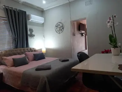 a bedroom with a bed and a table in it at Mountainia Inn in Worcester