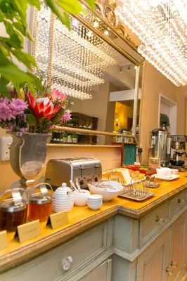 a counter with a mirror and some dishes on it at Maison Chablis Guest House in Franschhoek