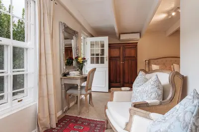 a living room with a couch and a table at Maison Chablis Guest House in Franschhoek