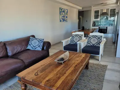 a living room with a couch and a coffee table at 109 da Gama on Beach in Strand