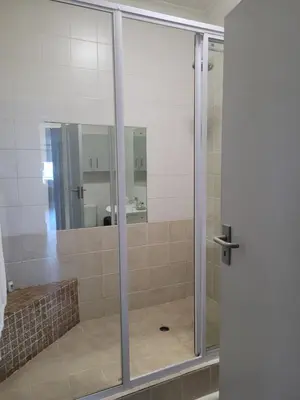 a shower with a glass door in a bathroom at 109 da Gama on Beach in Strand