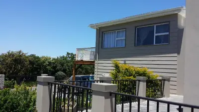 a house with a fence and a balcony at 29 Carissa Street in Somerset West