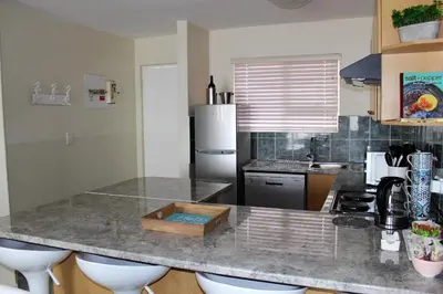 a kitchen with a counter top and a refrigerator at 605 Nautica in Bloubergstrand