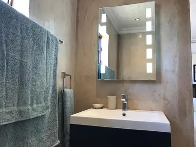 a bathroom with a sink and a mirror at Olive Hill Guest House in Robertson