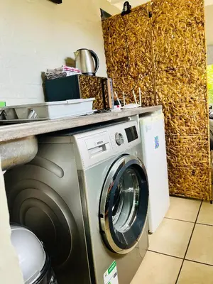 a washing machine in a kitchen with a counter at Lemontree in Hermanus