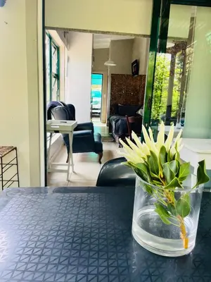 a vase filled with flowers sitting on a table at Lemontree in Hermanus