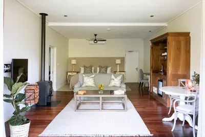 a living room with a couch and a table at Angala in Simondium