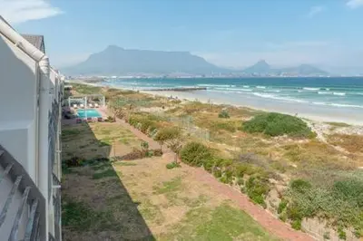 a view of a beach and the ocean from a building at 325 Leisure Bay Cape Town in Cape Town