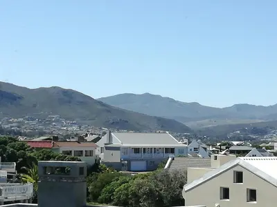 a view of a city with mountains in the background at Siesta in Hermanus