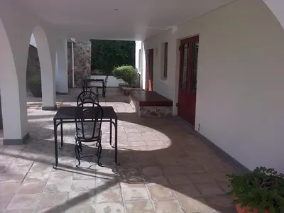 a patio with chairs and a table in a house at Pelagus Guest House in Hermanus
