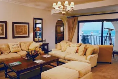 a living room with two couches and a table at Pelagus Guest House in Hermanus