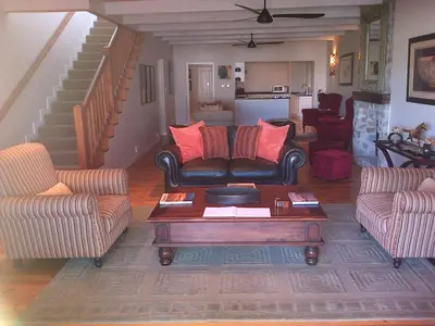 a living room with two couches and a coffee table at Nautilus Guest House in Hermanus